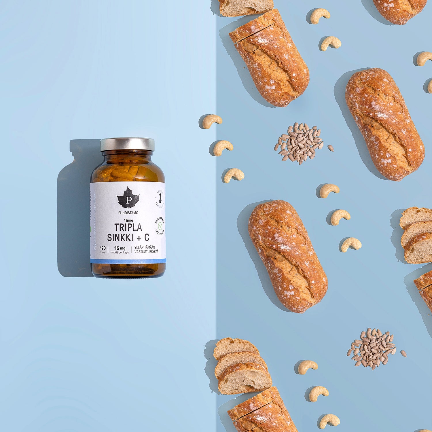 Tripla Sinkki beside baked goods and nuts on a blue background.