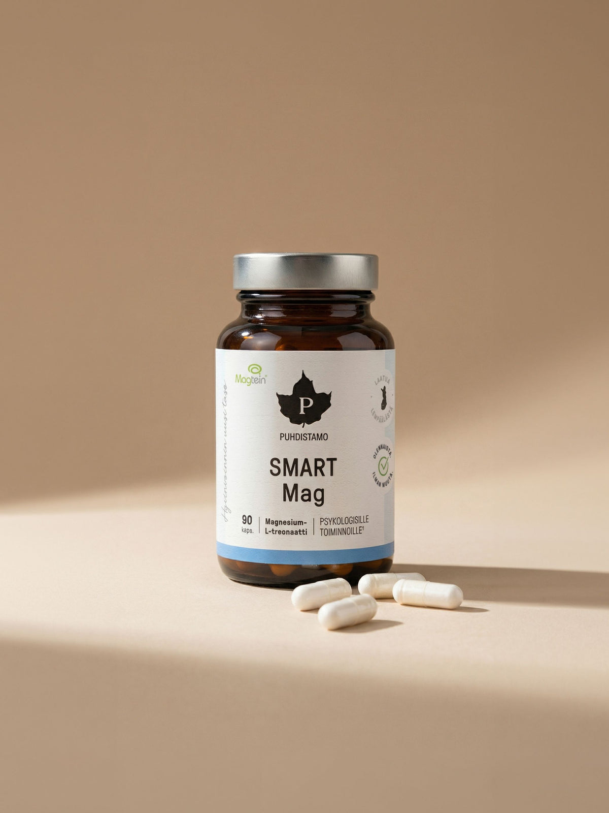 Puhdistamon Smart Mag 90 kapselipurkki ja kalaöljykapseleita beigellä taustalla
