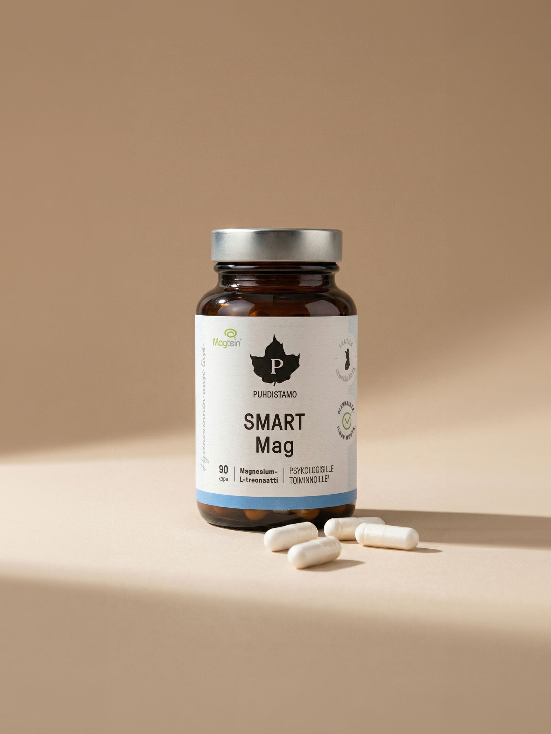 Puhdistamon Smart Mag 90 kapselipurkki ja kalaöljykapseleita beigellä taustalla